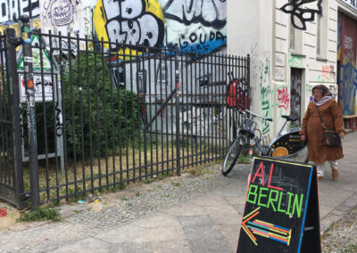 a-woman-passing-next-to-AL-Berlin-Cafe-Entrance-Through-Skalitzer-Park